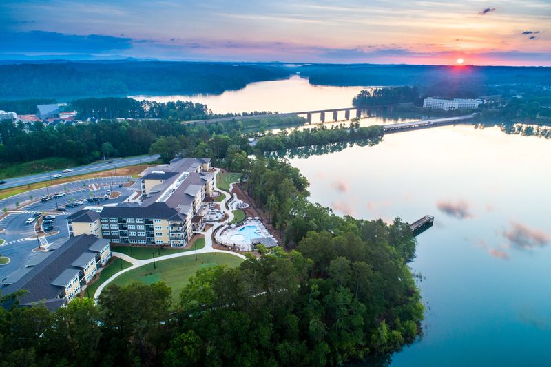 Lakeside Lodge's rec field, pool, firepit, and amphitheater enjoy a waterfront view of a late-spring sunrise over Lake Hartwell.