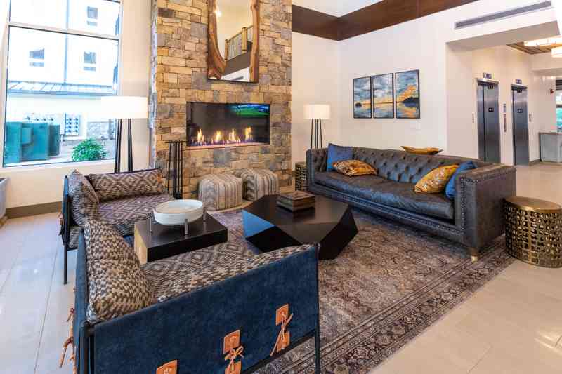An embedded fireplace and modern rustic furnishings adorn Lakeside Lodge's lobby.